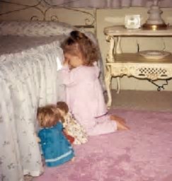 59. Girl-praying-with-dolls